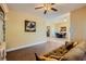 Inviting living room featuring wood floors, a ceiling fan, and a glimpse into the dining area at 7418 Lawrence Powers Ct, Las Vegas, NV 89129