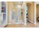 The travertine shower with a bench makes this part of the main bathroom luxurious at 7418 Lawrence Powers Ct, Las Vegas, NV 89129