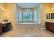 Bright main bathroom with soaking tub beneath a window for natural light at 7418 Lawrence Powers Ct, Las Vegas, NV 89129