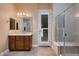 Enjoy this bright main bathroom with a travertine shower, travertine floors, and a spacious vanity at 7418 Lawrence Powers Ct, Las Vegas, NV 89129