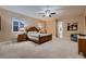 Spacious main bedroom features neutral walls, carpet, plantation shutters, and a ceiling fan with lights at 7418 Lawrence Powers Ct, Las Vegas, NV 89129