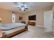 Neutral colored main bedroom with a ceiling fan, carpet, and ensuite bathroom provides a relaxing retreat at 7418 Lawrence Powers Ct, Las Vegas, NV 89129