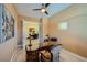 Well-lit home office with French doors and a view of the dining room at 7418 Lawrence Powers Ct, Las Vegas, NV 89129