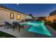 Relaxing backyard pool with lounge chairs, umbrella, and water features in a private setting at 7418 Lawrence Powers Ct, Las Vegas, NV 89129
