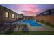Relaxing backyard featuring a private pool with sun loungers, a waterfall feature, and lush landscaping at 7418 Lawrence Powers Ct, Las Vegas, NV 89129