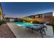 Inviting backyard pool featuring a water fountain and an outdoor umbrella for shade and relaxation at 7418 Lawrence Powers Ct, Las Vegas, NV 89129