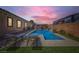 Inviting pool with a water feature, surrounded by greenery and providing a serene backyard oasis at 7418 Lawrence Powers Ct, Las Vegas, NV 89129