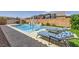 Backyard pool with lounge chairs, umbrella, and water features, perfect for outdoor enjoyment at 7418 Lawrence Powers Ct, Las Vegas, NV 89129