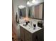 Bathroom featuring a gray vanity with modern fixtures and a gray-trimmed mirror at 809 Rock Springs Dr # 202, Las Vegas, NV 89128