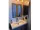 Bathroom featuring a white vanity with modern fixtures and a wood-trimmed mirror at 809 Rock Springs Dr # 202, Las Vegas, NV 89128