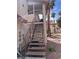 Staircase leading to an upper unit, next to utilities, with palm trees and part of the roof visible nearby at 809 Rock Springs Dr # 202, Las Vegas, NV 89128