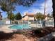Community pool is fenced and includes a water access ladder, and is surrounded by trees and common-area landscaping at 809 Rock Springs Dr # 202, Las Vegas, NV 89128
