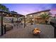 Outdoor living with a gazebo, fire pit, and hot tub for relaxation and entertaining in the landscaped backyard at 8208 Fritzen Ave, Las Vegas, NV 89131