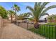 Fenced backyard with a gazebo, hot tub, mature palm trees and a patio at 8208 Fritzen Ave, Las Vegas, NV 89131