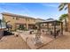 Landscaped backyard featuring a patio, gazebo, seating, palm trees and an outdoor hot tub at 8208 Fritzen Ave, Las Vegas, NV 89131