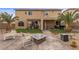 Spacious backyard with fire pit, lounge chairs, and a grill, great for entertaining at 8208 Fritzen Ave, Las Vegas, NV 89131