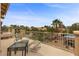 Relaxing balcony featuring comfortable seating with a view of the sparkling pool and lush tropical landscaping at 8208 Fritzen Ave, Las Vegas, NV 89131