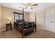 Comfortable bedroom features a four-poster bed, neutral walls, and a ceiling fan at 8208 Fritzen Ave, Las Vegas, NV 89131