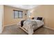 Cozy bedroom showcases neutral walls, plush carpet, and a window creating a bright and relaxing ambiance at 8208 Fritzen Ave, Las Vegas, NV 89131