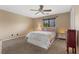 Relaxing bedroom featuring neutral-toned walls, plush carpeting, a ceiling fan, and lots of natural light at 8208 Fritzen Ave, Las Vegas, NV 89131
