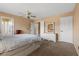 Cozy bedroom features neutral-toned walls, plush carpeting, a ceiling fan, and lots of natural light at 8208 Fritzen Ave, Las Vegas, NV 89131