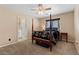 Comfortable bedroom features a four-poster bed, neutral walls, and carpeted flooring at 8208 Fritzen Ave, Las Vegas, NV 89131