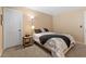 Cozy bedroom showcases neutral walls, plush carpet, and an accent side table creating a relaxing ambiance at 8208 Fritzen Ave, Las Vegas, NV 89131