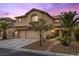 Inviting two-story home with a three-car garage, mature palm trees, and manicured landscaping at 8208 Fritzen Ave, Las Vegas, NV 89131