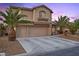 Inviting two-story home with a three-car garage, desert landscaping, and mature palm trees at 8208 Fritzen Ave, Las Vegas, NV 89131