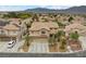 Charming two-story home with a three-car garage, mature palm trees, and desert landscaping at 8208 Fritzen Ave, Las Vegas, NV 89131
