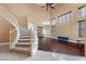 Grand foyer with a curved staircase, high ceilings, and hardwood floors, offering a luxurious entrance at 8208 Fritzen Ave, Las Vegas, NV 89131