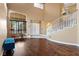Open-concept foyer with wood floors, large windows, and a staircase at 8208 Fritzen Ave, Las Vegas, NV 89131