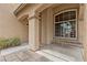 Charming covered front porch with decorative columns, seating, and desert landscaping for curb appeal at 8208 Fritzen Ave, Las Vegas, NV 89131