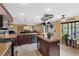 Spacious kitchen with a center island, stainless steel appliances, and dark wood cabinetry at 8208 Fritzen Ave, Las Vegas, NV 89131