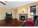 Cozy living area with a fireplace, built-in shelving, and hardwood floors at 8208 Fritzen Ave, Las Vegas, NV 89131