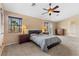 Well-lit main bedroom with many windows for lots of natural light and neutral colored carpet flooring at 8208 Fritzen Ave, Las Vegas, NV 89131