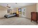 Large main bedroom that opens up to a balcony with bright light shining through the doorway at 8208 Fritzen Ave, Las Vegas, NV 89131