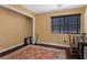 Well-lit home office with a large window, desk, and a decorative rug at 8208 Fritzen Ave, Las Vegas, NV 89131