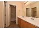 Bright bathroom featuring a double sink vanity, large mirror, and separate toilet and shower area at 8842 Duncan Barrel Ave # 101, Las Vegas, NV 89178