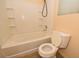 Clean and modern bathroom with a shower-tub combination featuring tiled walls and built-in shelving at 8842 Duncan Barrel Ave # 101, Las Vegas, NV 89178