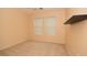 Comfortable bedroom featuring two windows and a built-in wall shelf at 8842 Duncan Barrel Ave # 101, Las Vegas, NV 89178