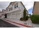 Charming townhome featuring a three car garage and well-maintained landscaping, creating an inviting curb appeal at 8842 Duncan Barrel Ave # 101, Las Vegas, NV 89178