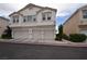 Three-story condo building showing garages and ample parking space at 8842 Duncan Barrel Ave # 101, Las Vegas, NV 89178
