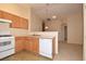 Functional kitchen featuring wooden cabinets, modern appliances, and a dining area at 8842 Duncan Barrel Ave # 101, Las Vegas, NV 89178