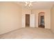 Large main bedroom with carpet, neutral paint and arched bathroom entrance at 8842 Duncan Barrel Ave # 101, Las Vegas, NV 89178