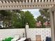 Relaxing backyard with lounge chairs, brick wall, and lovely views of the trees and roofs in the neighborhood at 9028 Cypress Point Way, Las Vegas, NV 89117