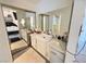 Bright bathroom featuring a white vanity with vessel sink, large mirror, and views into the bedroom and shower at 9028 Cypress Point Way, Las Vegas, NV 89117