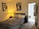 Cozy bedroom with a patterned bedspread, featuring simple decor and a comfortable, inviting atmosphere at 9028 Cypress Point Way, Las Vegas, NV 89117