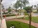 Attractive front yard featuring fresh grass, a paver walkway, and lush plantings at 9028 Cypress Point Way, Las Vegas, NV 89117