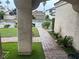 Paver walkway with fresh grass and palm trees leads to the home's front door at 9028 Cypress Point Way, Las Vegas, NV 89117